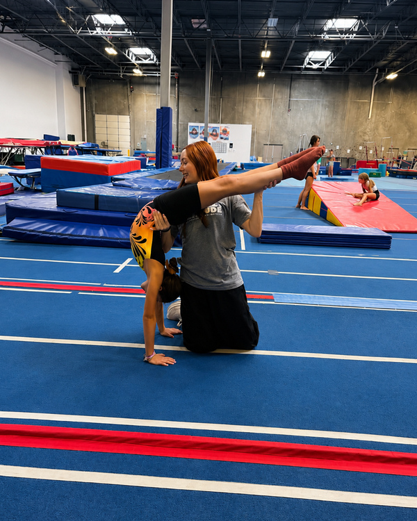 Coach assisting an athlete with flexibility training