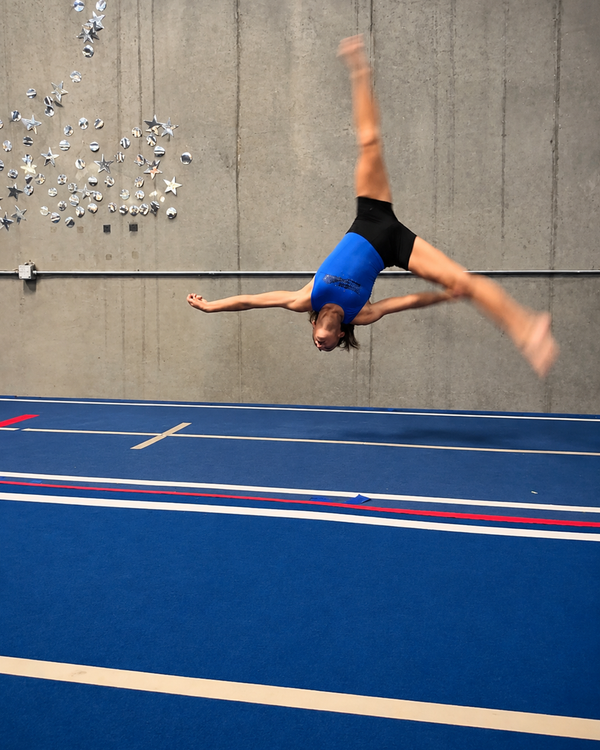 Athlete performing a layout on the tumble track